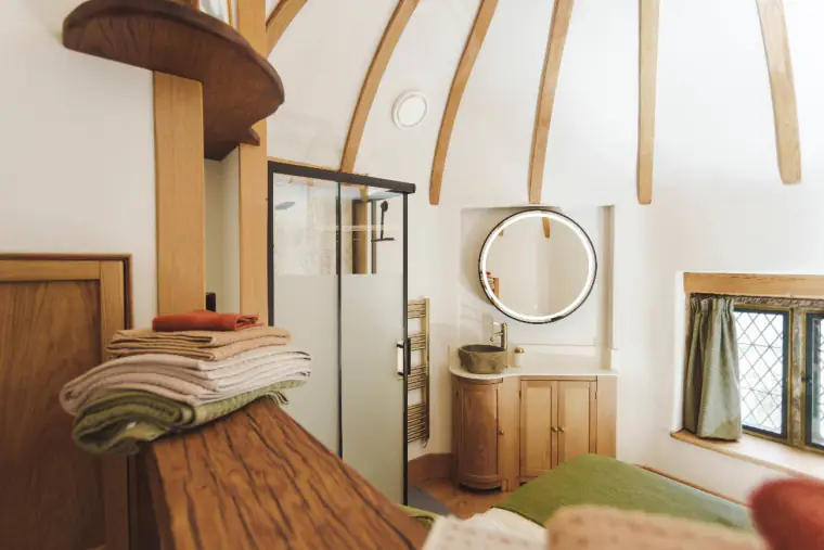 Bed and bathroom beneath the beams