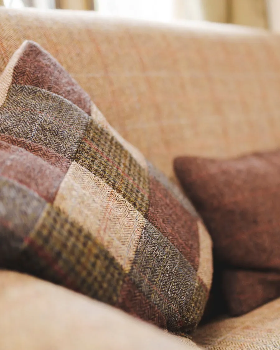 Tweed cushions on a sofa inside Bottle Lodge